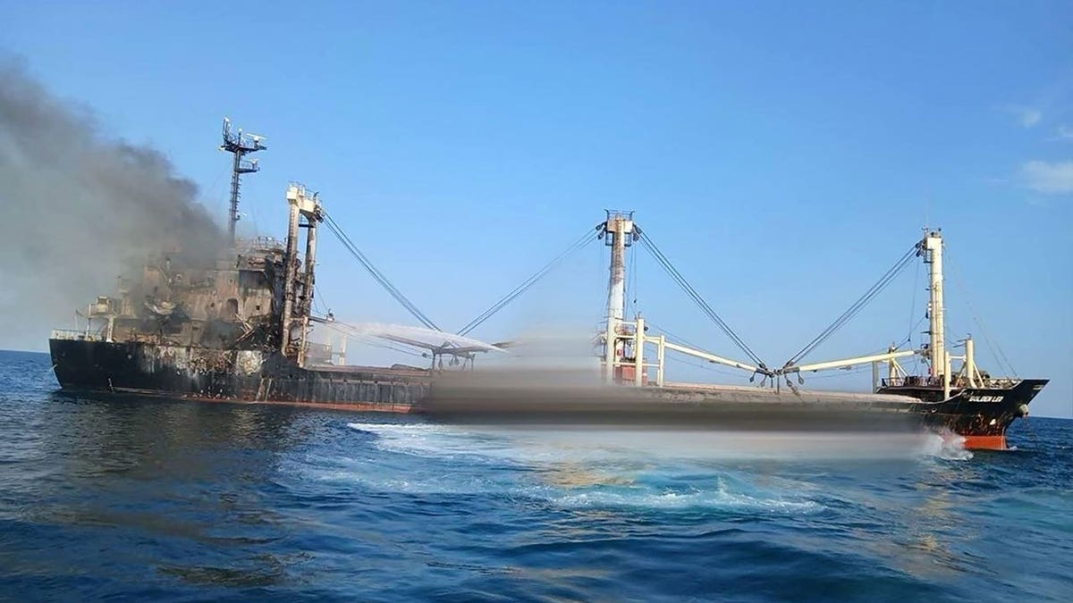 Smoke rises from the Guinea-Bissau-flagged cargo ship Golden Leo after a Russian missile attack.