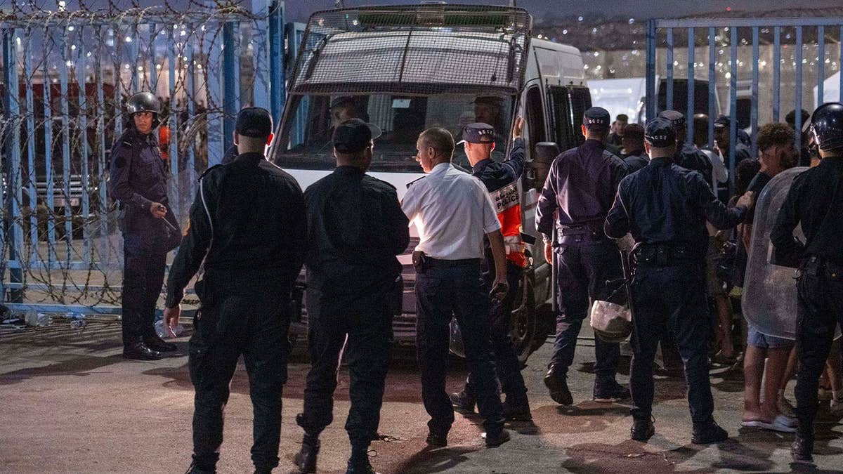 Spanish security forces guard the border as migrants attempt to cross from Morocco into Ceuta