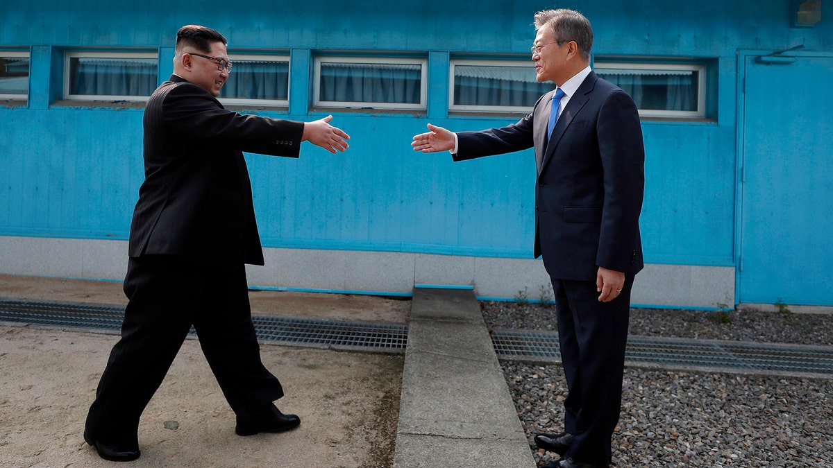 North Korean leader Kim Jong Un, left, prepares to shake hands with South Korean President Moon Jae-in at the border village of Panmunjom in Demilitarized Zone Friday, April 27, 2018. Their discussions will be expected to focus on whether the North can be persuaded to give up its nuclear bombs. (Korea Summit Press Pool via AP)