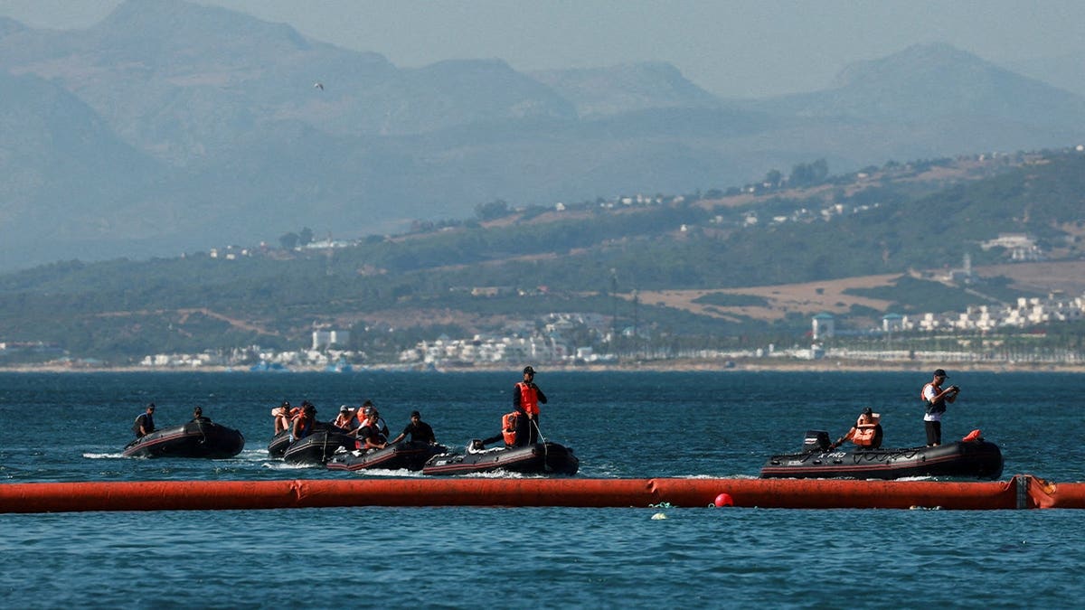 Members of the Royal Moroccan Navy patrol on the Moroccan side of the floating barrier off the border with Morocco, following mass crossings of migrants on foot and by sea from Morocco into Spanish territory, as seen from Ceuta, Spain, August 2, 2026.