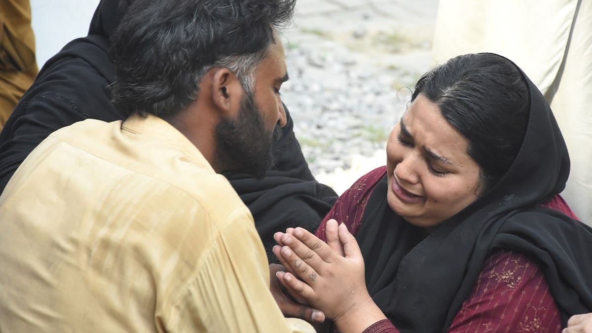 Parents react after their child died in a hospital fire in Islamabad, Pakistan, Wednesday, Aug. 26, 2026.