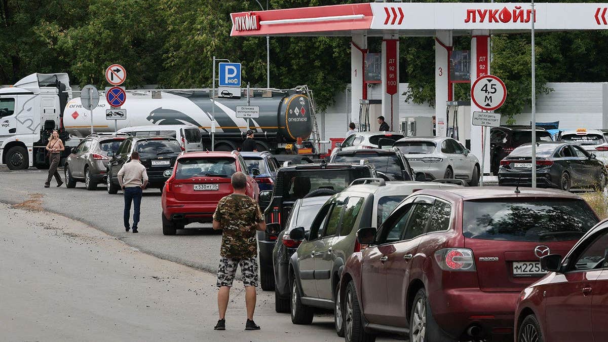 Cars queue to refuel at a Lukoil fuel station in Russia