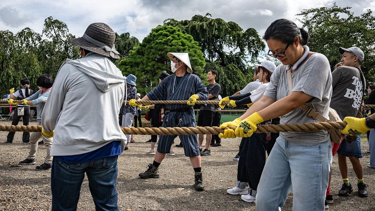 Participants pull Hirosaki Castle with ropes to its original position in Hirosaki, Japan.
