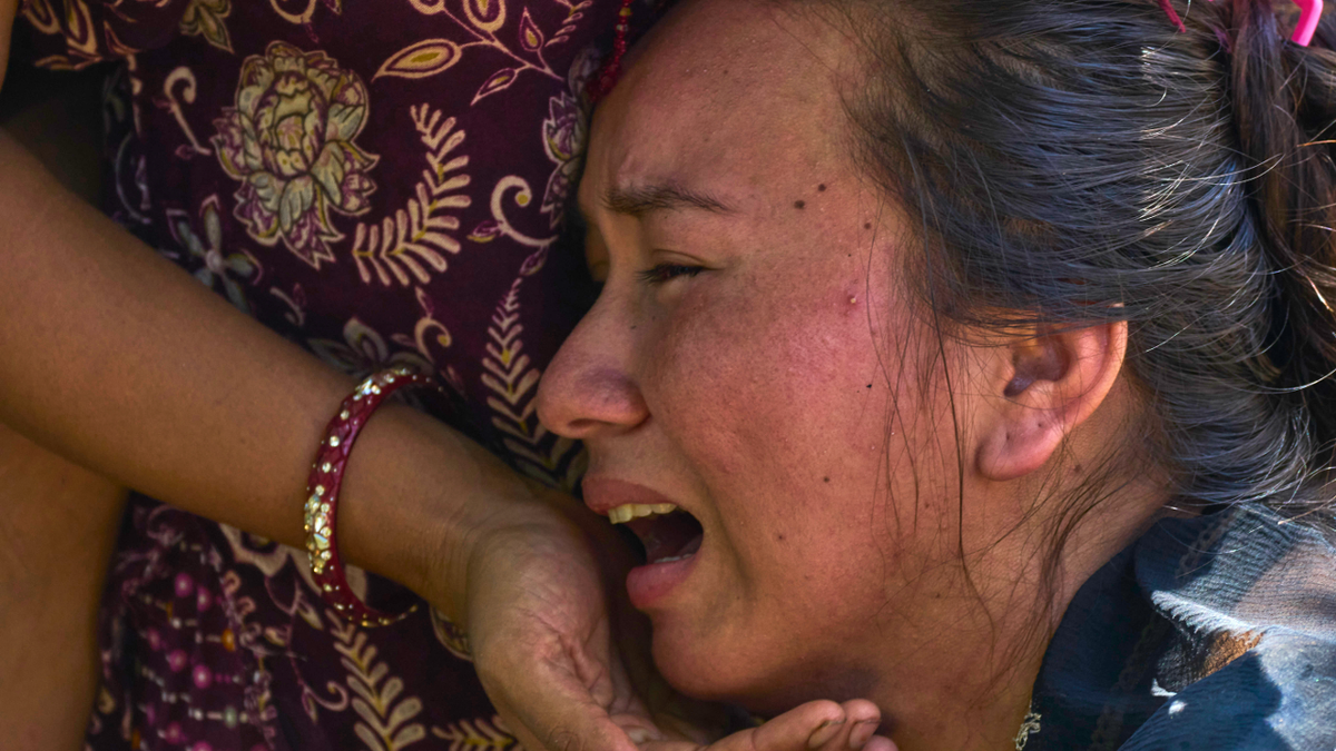 A girl cries as she waits for news of relatives missing