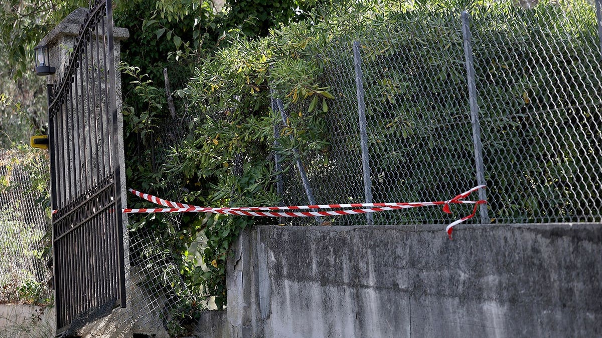 Police tape secures an area near a hole in the Renoir Museum's outer fence.