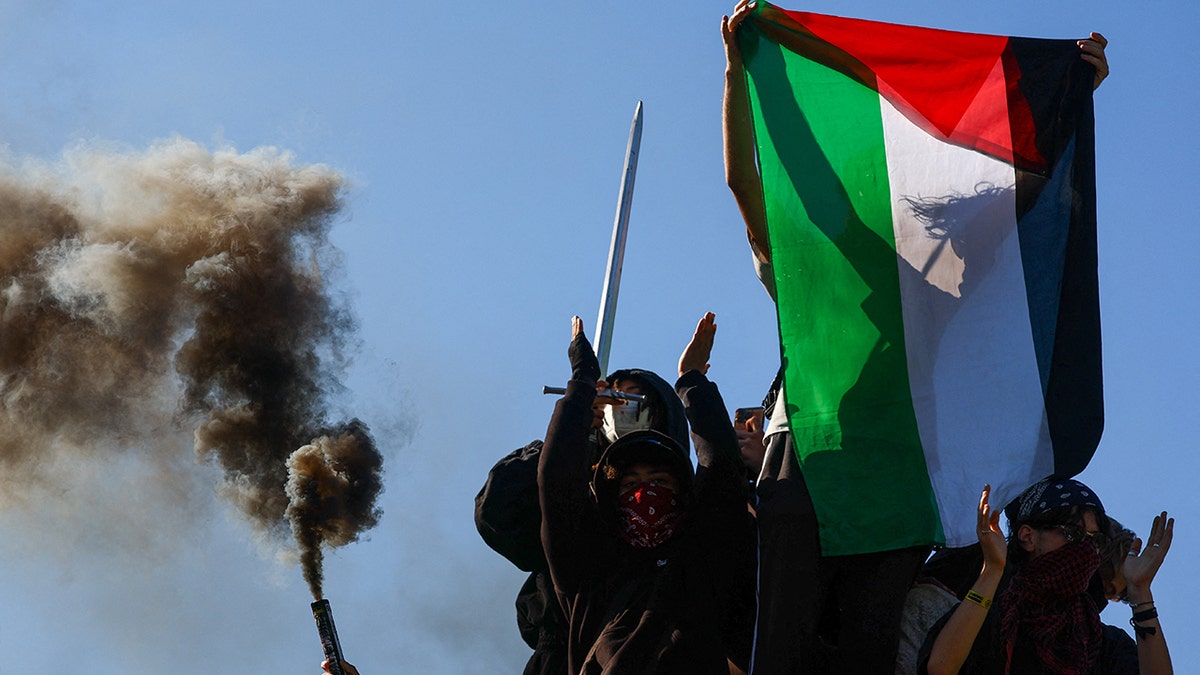 Protesters hold a Palestinian flag on the day French high school and university students attend a demonstration in Strasbourg as part of a nationwide day of protests and blockades, voicing anger over overcrowded classrooms, teacher shortages and dilapidated school buildings, which students blame on years of underinvestment, France, October 6, 2026. REUTERS/Kai Pfaffenbach