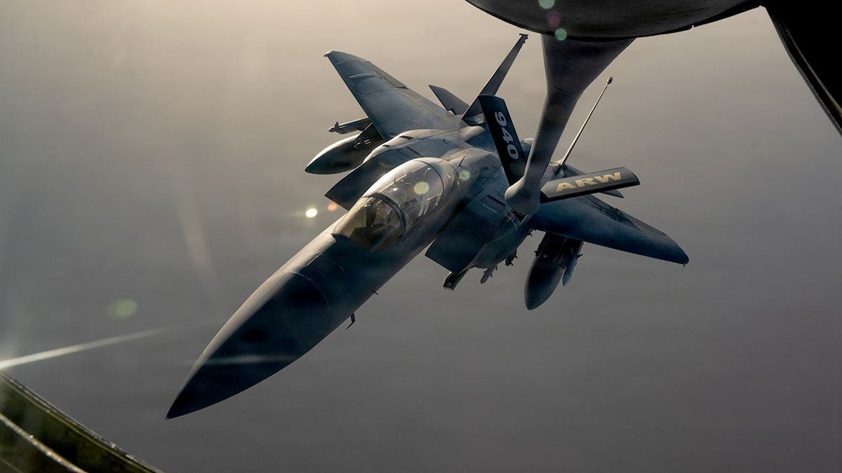 U.S. Air Force F-15E Strike Eagle is refueled in the sky