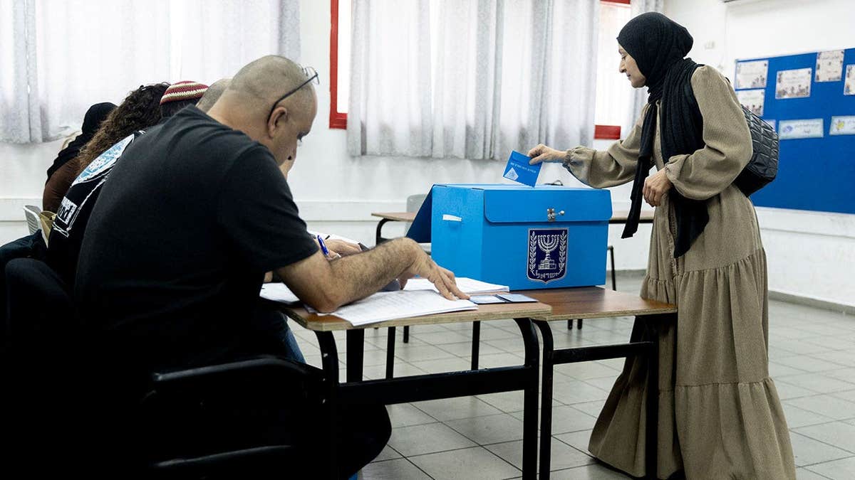 An Arab-Israeli woman casts her ballot during Israel's general elections on October 27, 2026 in Umm El Fahem, Israel