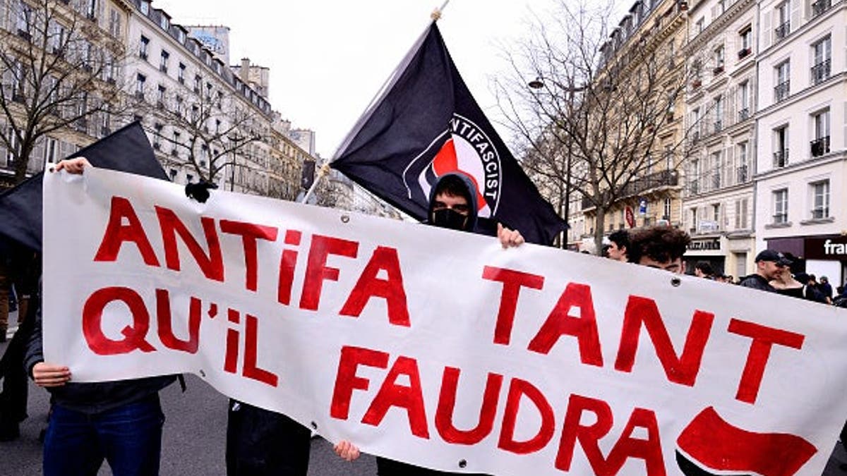 An Antifa flag and a banner reading