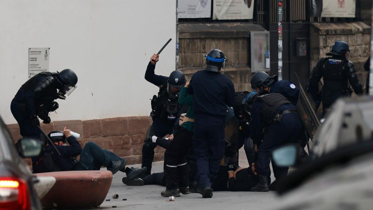 Police officers detain protesters during a demonstration in Strasbourg, France.