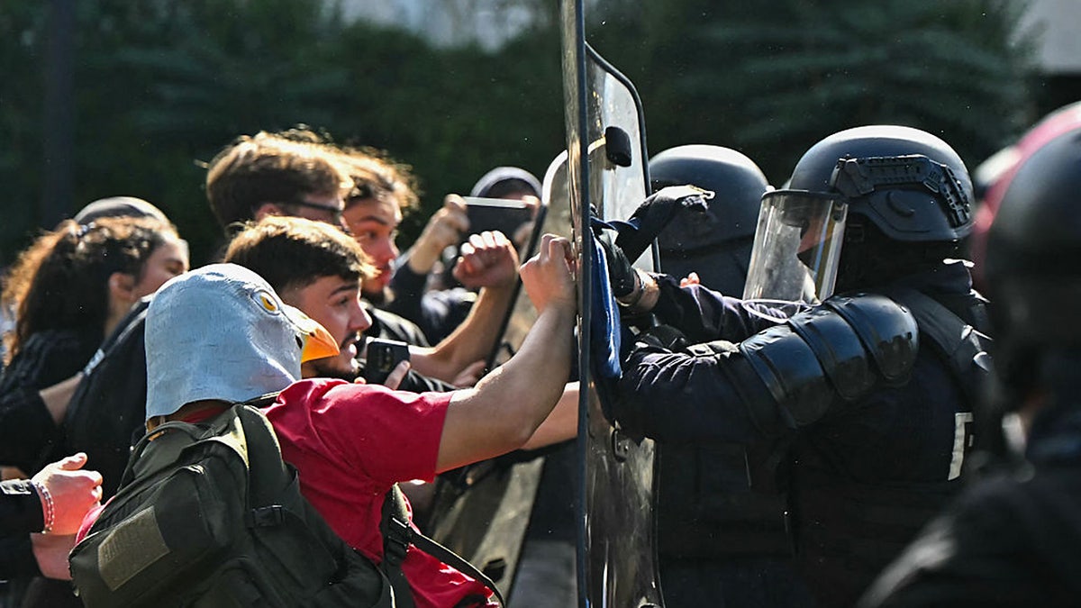 Anti-riot police officers face protesting students carrying out blockading action outside the secondary school Le Corbusier, in Aubervilliers, northern Paris on October 1, 2026.