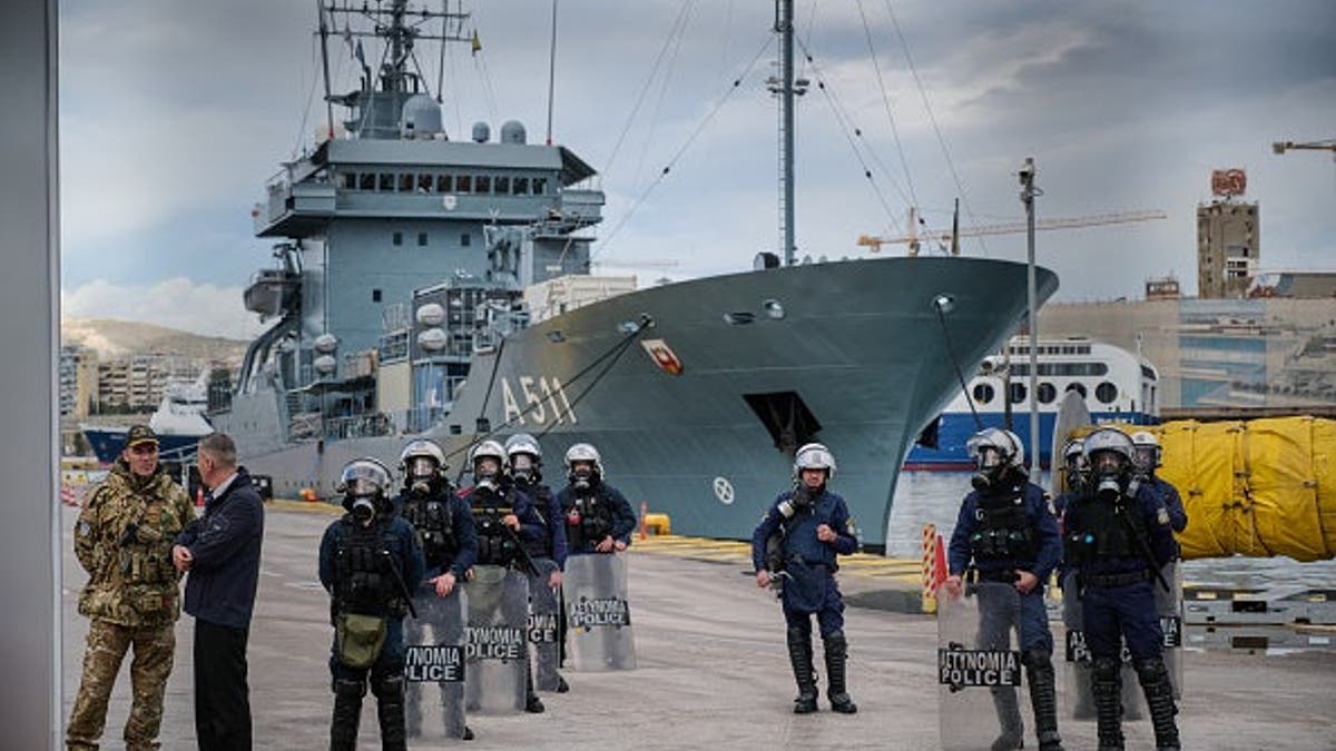 Greek riot police officers stand in front of an entrance at COSCO shipping port during a demonstration as part of a port workers strike called by the Greek labor union in Piraeus, near Athens on Feb. 6, 2026.