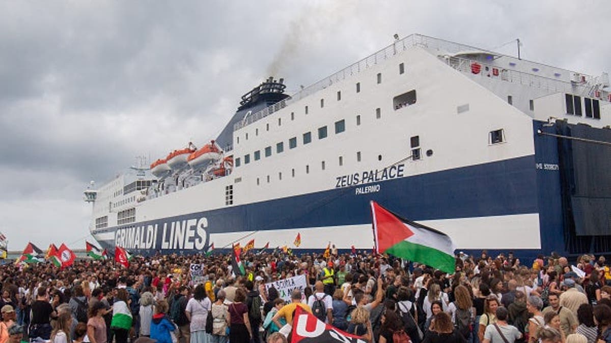 Dockworkers and students march through a port gate during a Gaza and Palestine protest in Livorno, Italy.