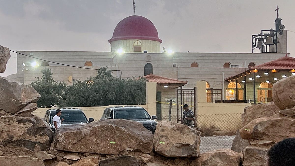 Security officer stands guard outside Greek Orthodox Church in Jordan.
