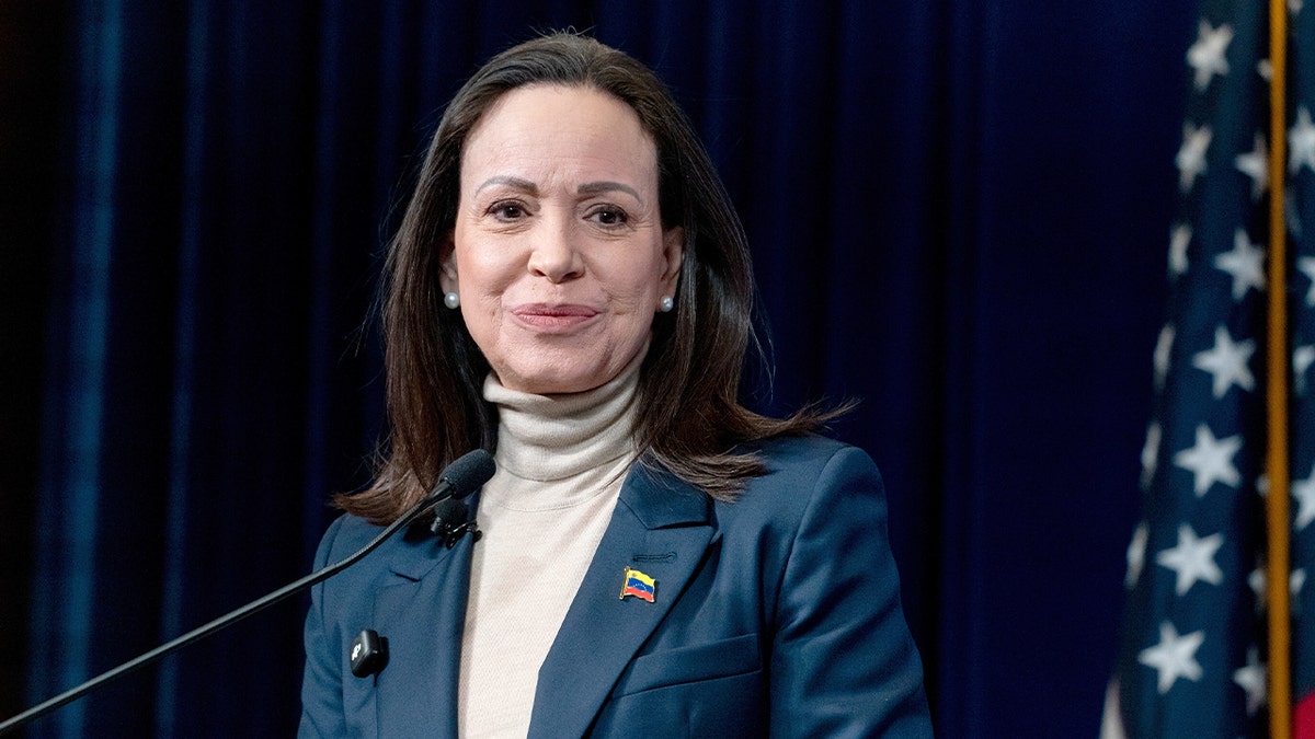 Venezuela’s opposition leader stands at a lectern speaking to reporters inside a Washington think tank.
