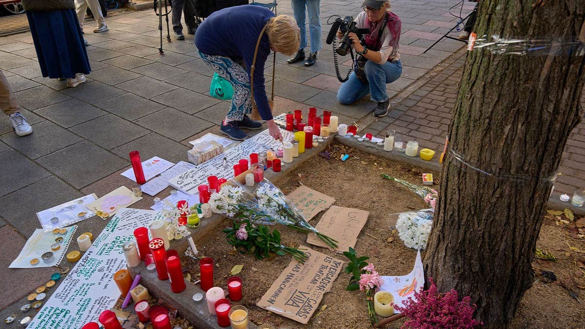 Flowers, candles and handwritten messages are placed at a memorial in Madrid, Spain, honoring María del Carmen Abascal, an 87-year-old woman whose eviction sparked protests over the country's housing crisis