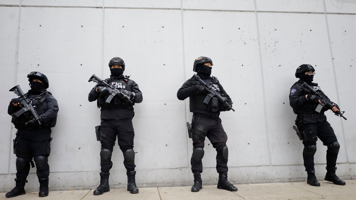 Mexican law enforcement stand guard on the heels of the death of Mexican drug trafficker